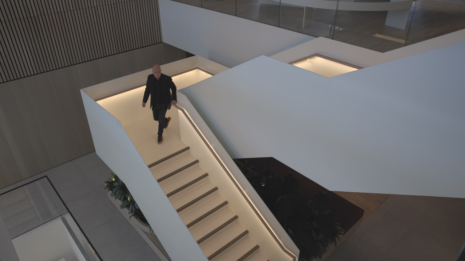 A lone figure on the stair, shot from above.