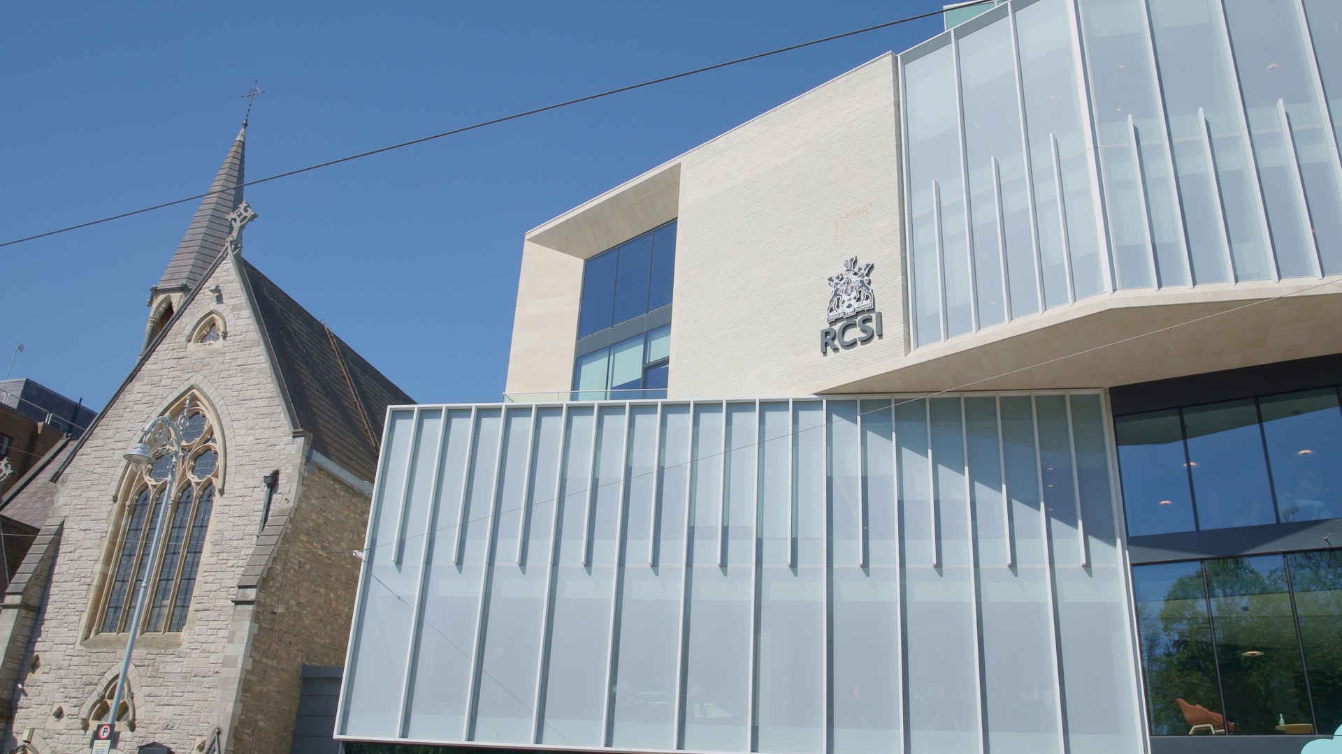 The RCSI facade beside the old church.