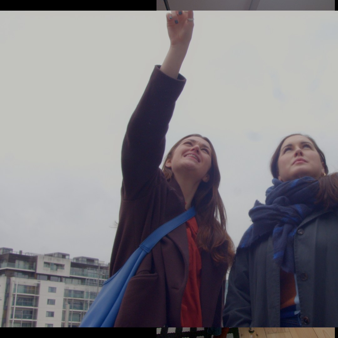 Pointing up at a building on a site visit.