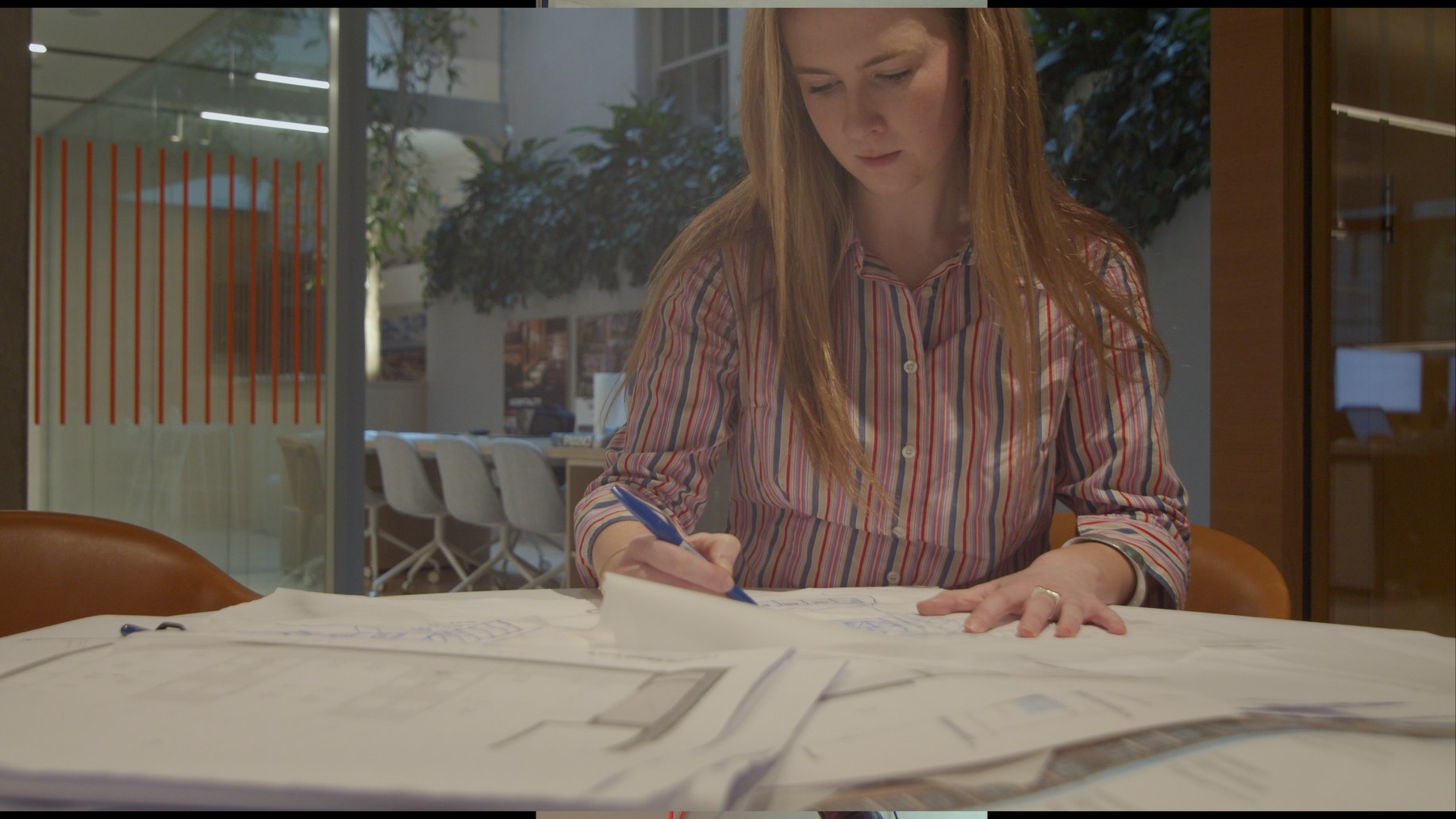 Working over drawings at a table in the office.