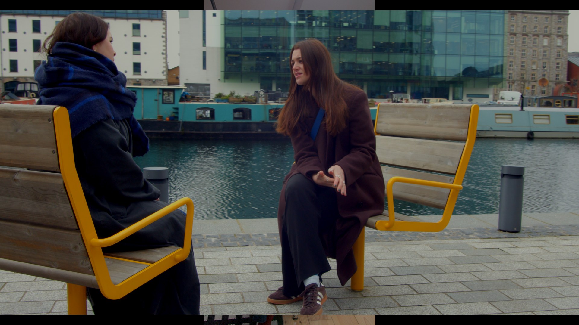 Talking on a bench by the water.