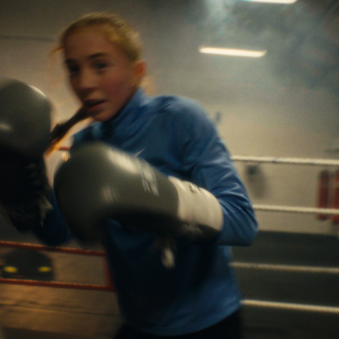 Throwing a punch towards camera inside the ring.