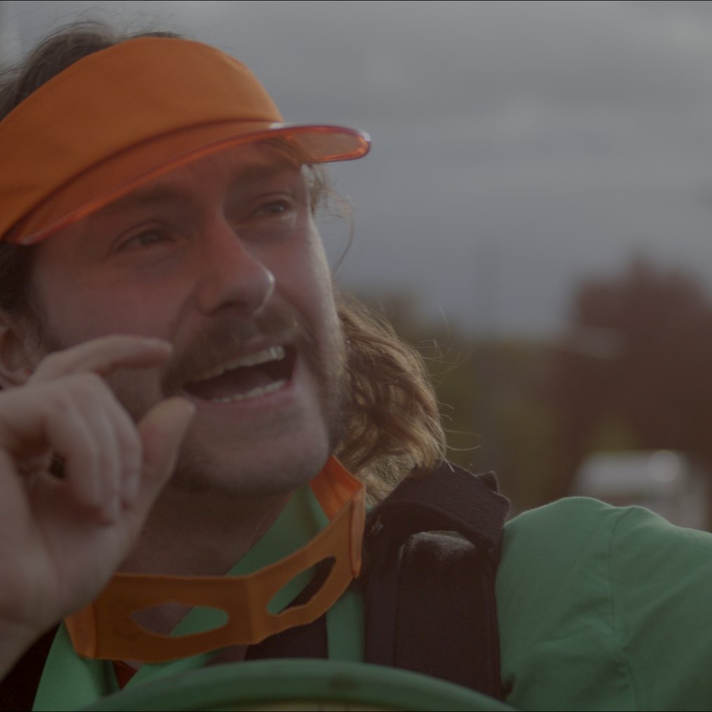 Iain in the orange visor on the Paris course, making a point to camera.